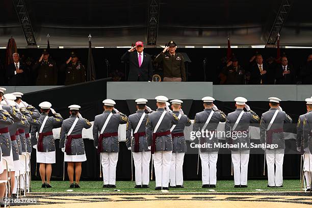 President Donald Trump and superintendent Lieutenant General Steven W. Gilland salute graduates of the United States Military Academy at West Point...