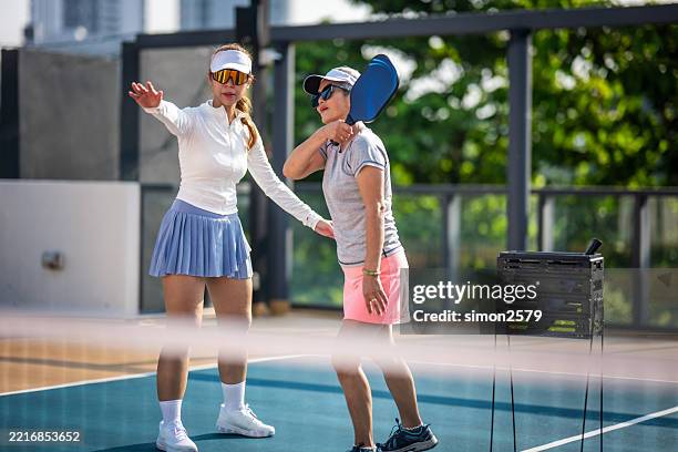 pro coaching in action: pickleball lessons outdoors - racquet sport stock pictures, royalty-free photos & images