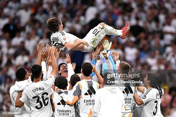 Luka Modric of Real Madrid is lifted in the air by his teammates following his final appearance for the team after the LaLiga match between Real...