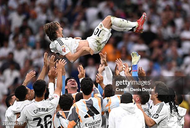 Luka Modric of Real Madrid is lifted in the air by his teammates following his final appearance for Real Madrid after the LaLiga match between Real...
