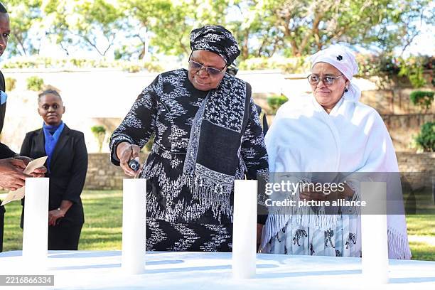 Dpatop - 28 May 2025, Namibia, Windhuk: Namibia's President Netumbo Nandi-Ndaitwah lights a candle in remembrance of the genocide by German colonial...