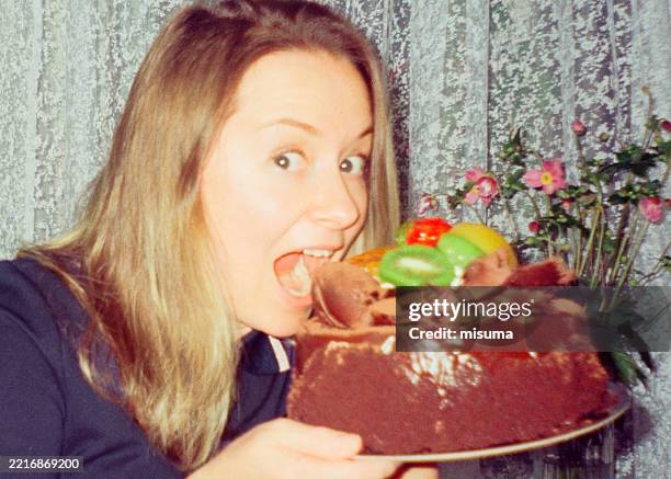 woman holds sponge cake. - addict stock pictures, royalty-free photos & images