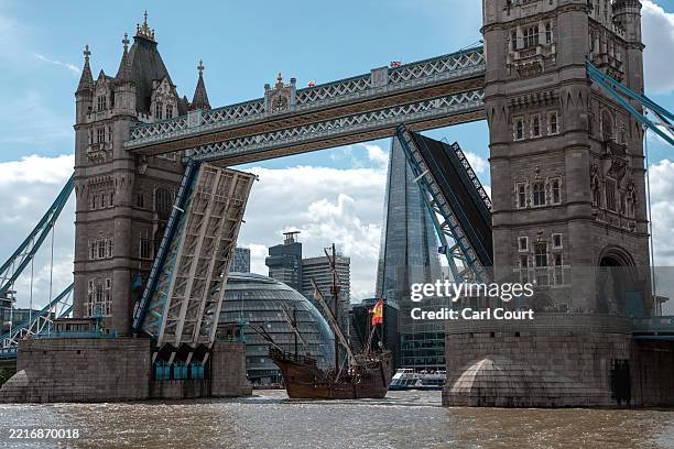 Replica of the Nao Santa Maria sails through Tower Bridge and into St Katharine Docks Marina on May 28, 2025 in London, England. The 200 ton...