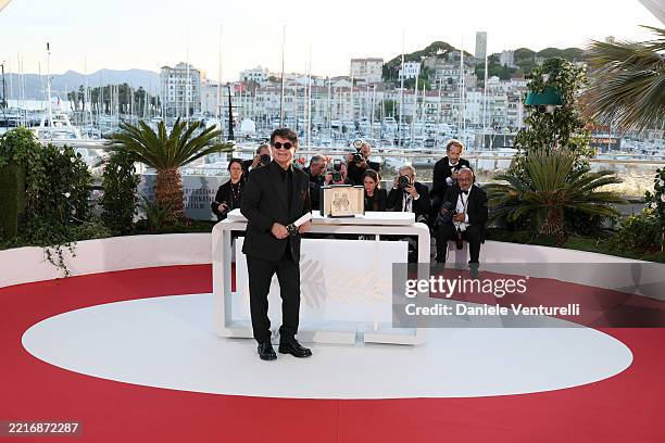 Jafar Panahi poses with the Palme D'Or award for “It Was Just an Accident” during the Palme D'Or winners photocall at the 78th annual Cannes Film...
