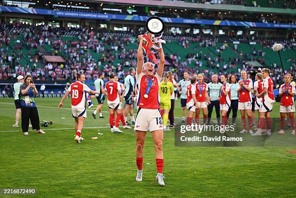 Chloe Kelly of Arsenal lifts the UEFA Women's Champions League trophy after her team's victory in the UEFA Women's Champions League final match...
