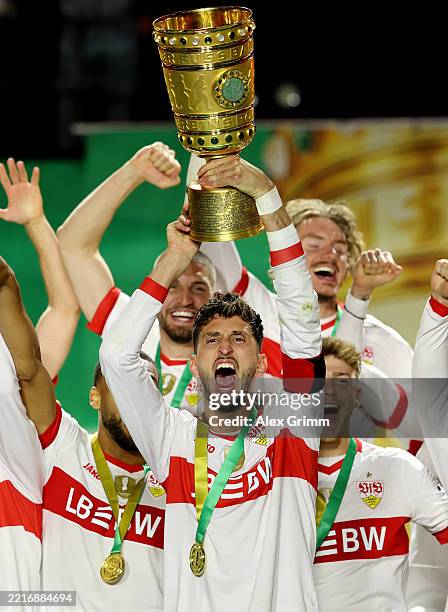 Atakan Karazor of VfB Stuttgart lifts the DFB-Pokal trophy after his team's victory in the DFB Cup Final 2025 between DSC Arminia Bielefeld and VfB...