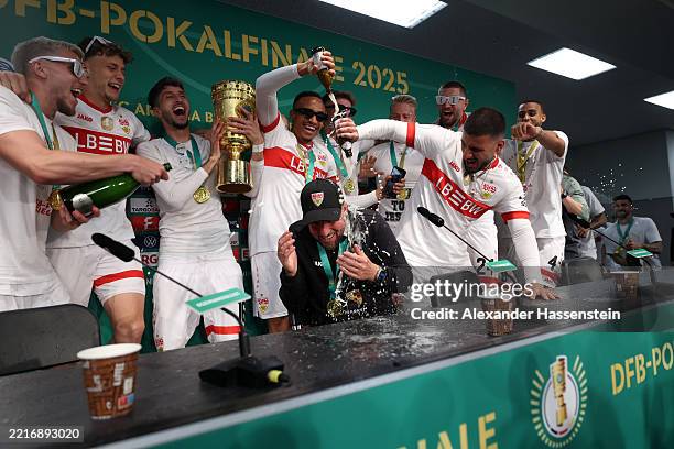 Sebastian Hoeness, Head Coach of VfB Stuttgart, celebrates victory with his players during the post match press conference after the DFB Cup Final...