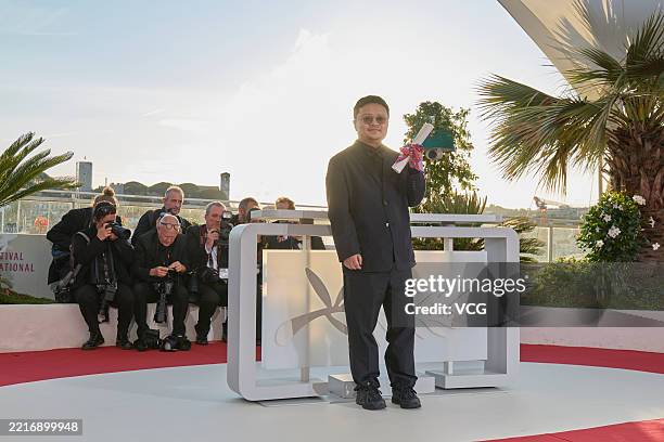 Director Bi Gan poses with the Special Prize Award for "Resurrection" during the Palme D'Or winners photocall at the 78th annual Cannes Film Festival...