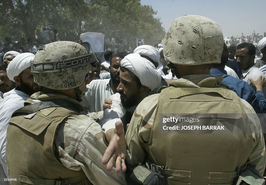 US soldiers guard a massive anti-US demo