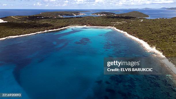 This aerial view shows fields of Posidonia Oceanica seagrass in the blue waters of the Adriatic Sea, at Sakarun Beach on Dugi Otok island near Bozava...