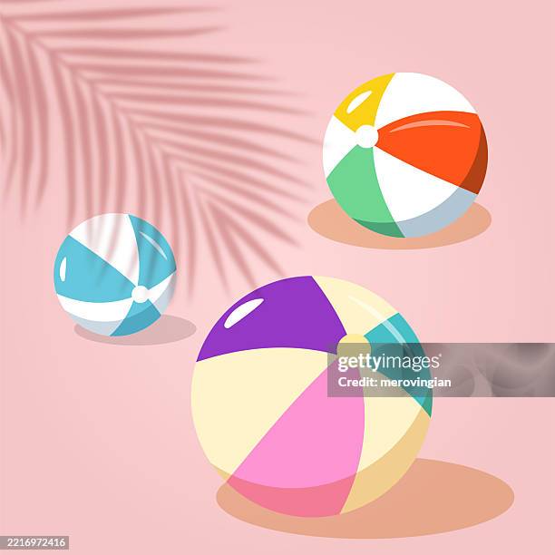 colorful beach balls on pink background - inflatable ball stock illustrations