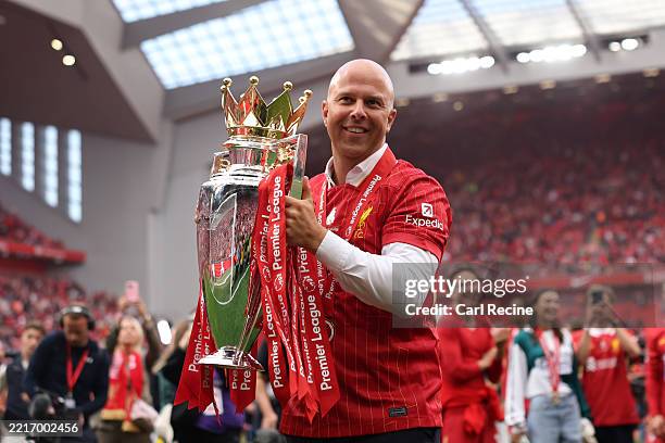 Arne Slot, Manager of Liverpool, celebrates with the Premier League trophy, as Liverpool are crowned the Champions of the Premier League for the...