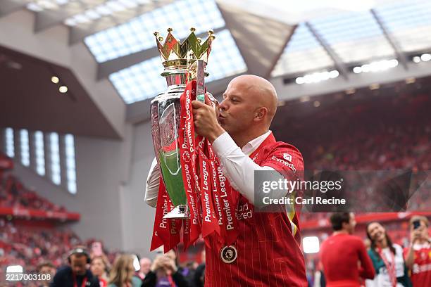 Arne Slot, Manager of Liverpool, kisses the Premier League trophy, as Liverpool are crowned the Champions of the Premier League for the 2024/25...
