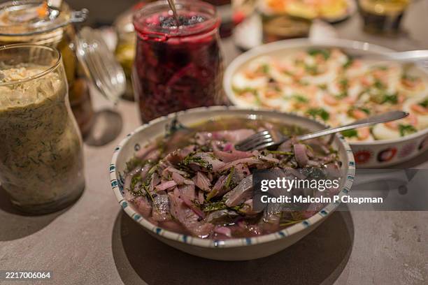 sill (pickled herring) on smörgåsbord - swedish christmas table (julbord) - pickled stock pictures, royalty-free photos & images