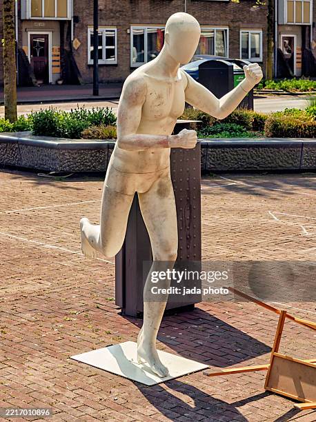mannequin in a running pose stands outside on the street - cut out clothing stock pictures, royalty-free photos & images