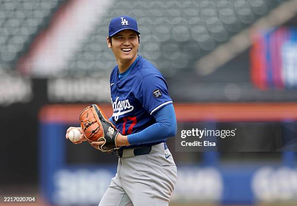 Shohei Ohtani of the Los Angeles Dodgers reacts after a pitch during live batting practice before the game between the New York Mets and the Los...
