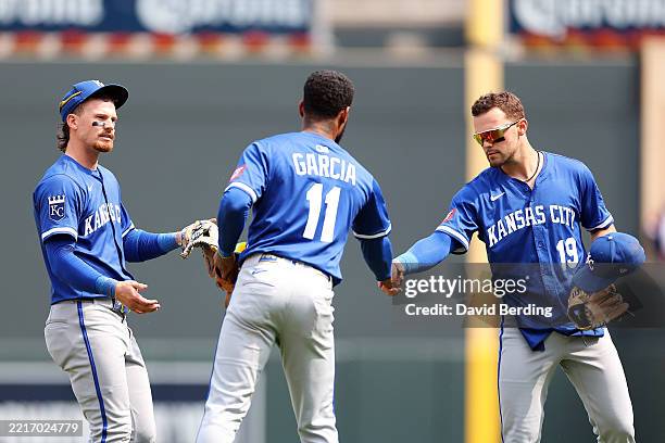 Bobby Witt Jr. #7, Maikel Garcia, and Michael Massey of the Kansas City Royals celebrate the win against the Minnesota Twins after the game at Target...