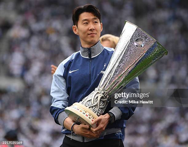 Son Heung-Min of Tottenham Hotspur holds the Europa League on a lap of honour after the Premier League match between Tottenham Hotspur FC and...