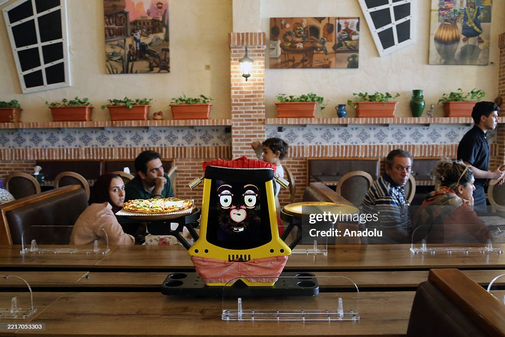 Robots serving as waiters provide a unique dining experience for customers in Tehran