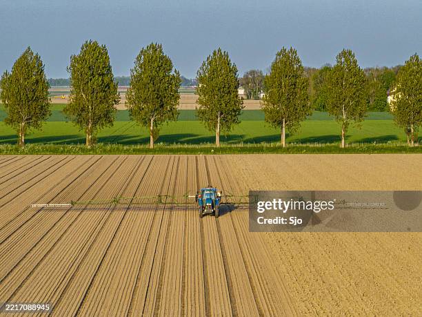 agricultural crops sprayer in a field seen from above - application form stock pictures, royalty-free photos & images