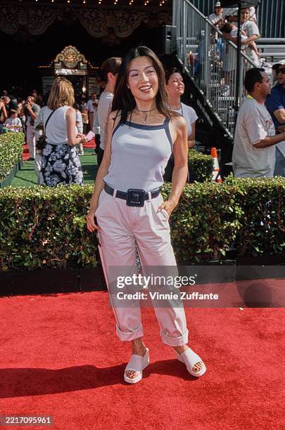 American actress Ming-Na Wen, wearing a blue vest with dark blue trim and white trousers, at the premiere of Walt Disney Pictures' 'Tarzan' at the El...