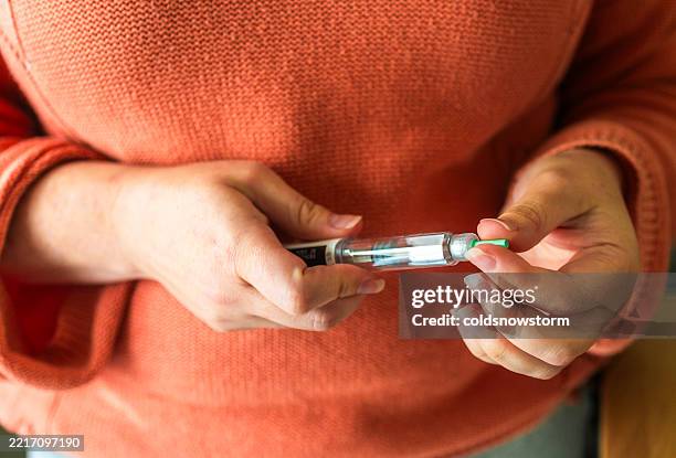 woman preparing to administer weight loss injection - mounjaro stock pictures, royalty-free photos & images