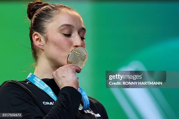Belgium's Nina Derwael kisses with her gold medal after winning the women's uneven bars final of the Men's and Women's Artistic Gymnastics European...