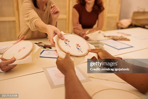women practicing embroidery in craft class - cross stitch stock pictures, royalty-free photos & images