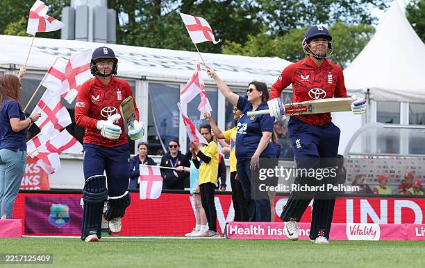 Sophia Dunkley and Danni Wyatt-Hodge of England walk out during the 3rd Women's Vitality IT20 match between England and West Indies at Ambassador...