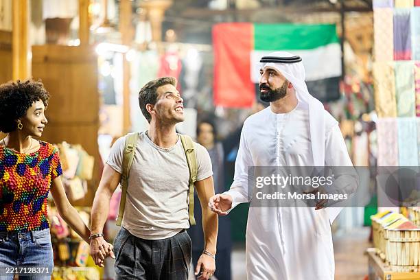 muslim tour guide assisting tourists on vacation - looking around stock pictures, royalty-free photos & images