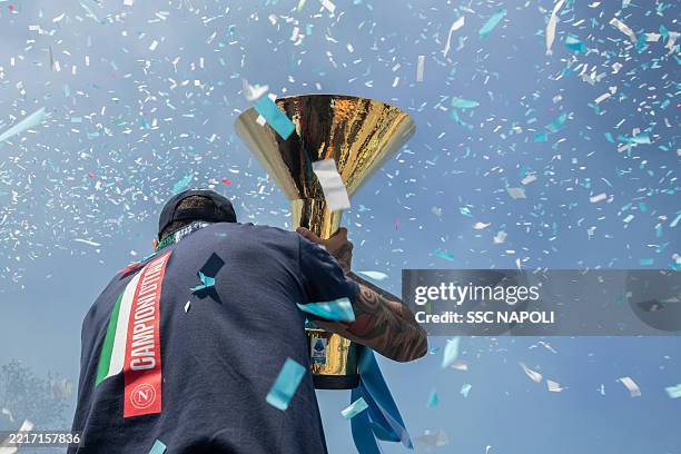 Giovanni di Lorenzo of SSC Napoli celebrates holding the Serie A Trophy inside the team bus following the club’s Scudetto victory on May 26 in...