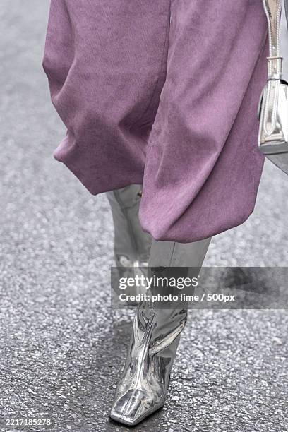 low section of woman walking on road - sapato cinzento imagens e fotografias de stock