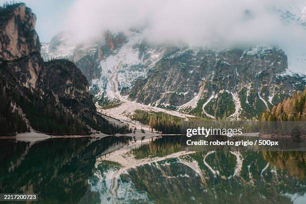 scenic view of lake and mountains - lago di braies foto e immagini stock