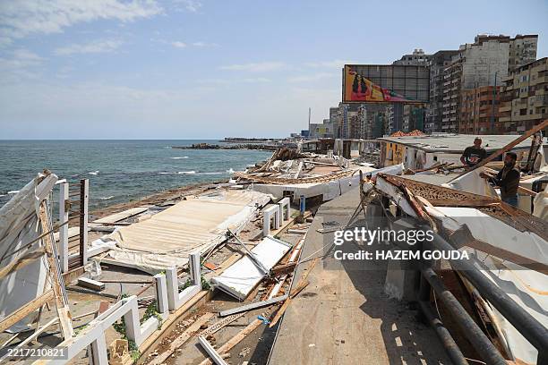 People clear debris from damaged seafront huts after a windstorm struck Egypt's northern city of Alexandria on the Mediterranean coast in the early...