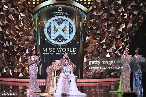 Thailand's Opal Suchata Chuangsri is congratulated by Czech model and Miss World 2024 Krystyna Pyszkova after winning the 72th Miss World 2025...
