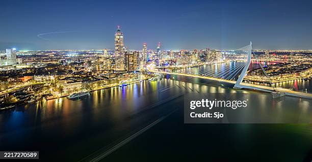 rotterdam skyline nighttime panorama view at erasmusbrug over the new maas - rotterdam stockfoto's en -beelden