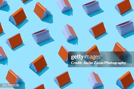 Pattern of orange books over a light blue background Pattern of orange books over a light blue background