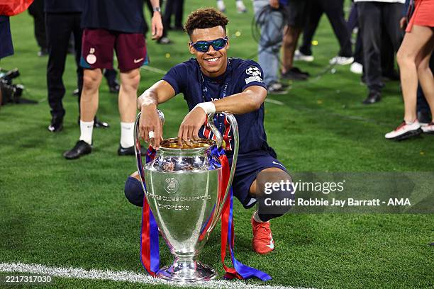 Desire Doue of Paris Saint Germain celebrates with the trophy after the UEFA Champions League Final 2025 between Paris Saint-Germain and FC...