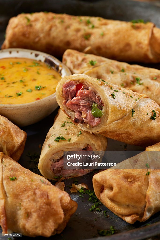 Philly Cheese Steak Egg Rolls with Spicy Cheese Dip