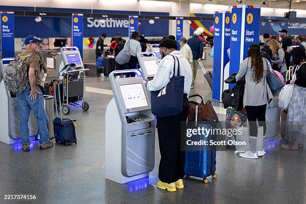 Southwest Airlines passengers check in for flights at Midway Airport May 27, 2025 in Chicago, Illinois. Beginning tomorrow, Southwest Airlines will...