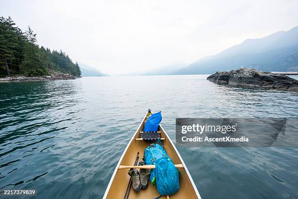 canoe bow and ocean and mountains - canoe stock pictures, royalty-free photos & images