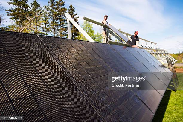 installing a solar ground array - renewable energy canada stock pictures, royalty-free photos & images