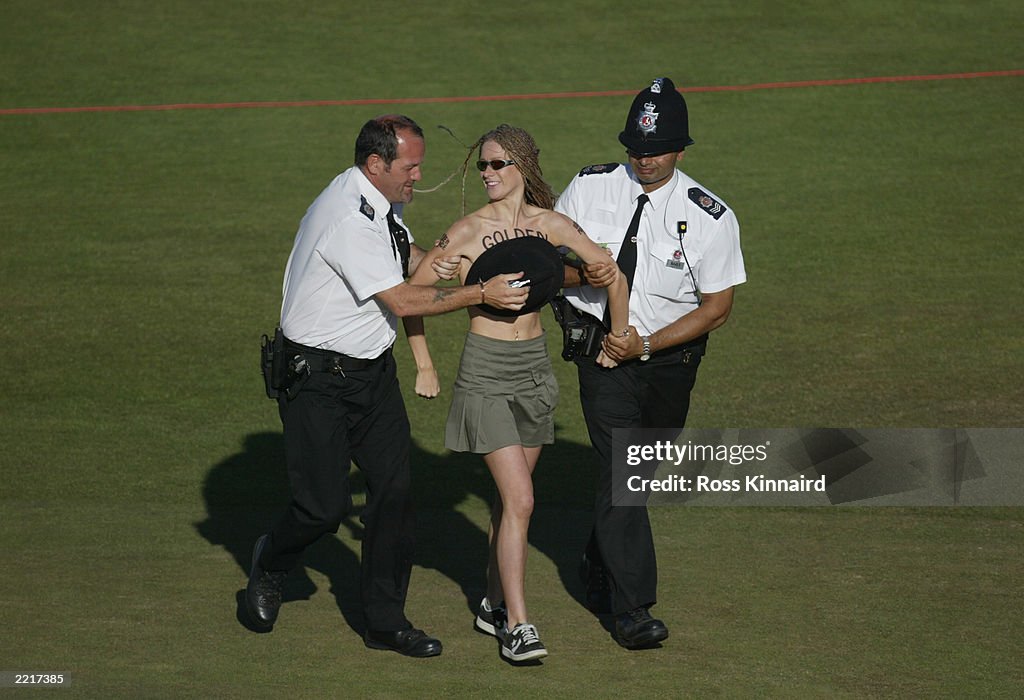 Police remove a streaker from the 18th green 