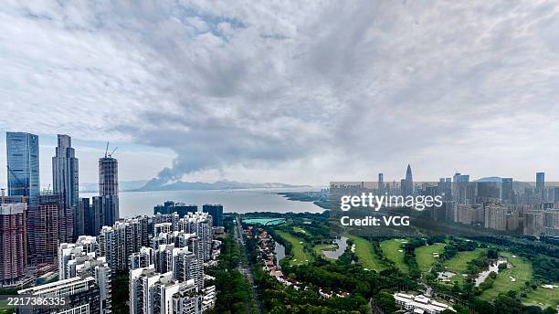 Smoke rises from a fire broke out at a logistics warehouse on Ha Tsuen Road in Tin Shui Wai on May 27, 2025 in Shenzhen, Guangdong Province of China....