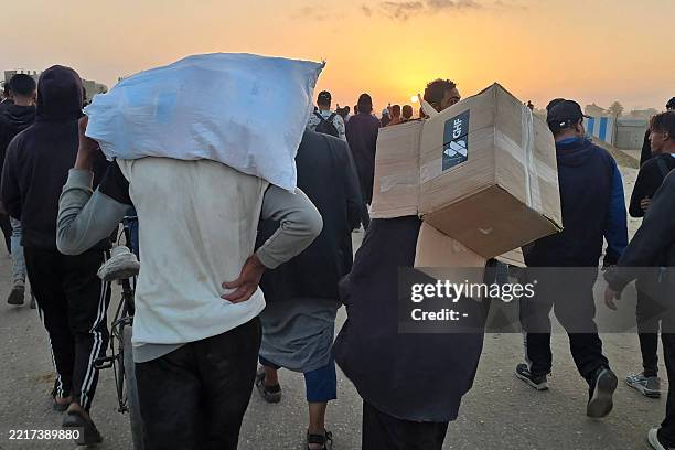 Youth carries an empty box of relief supplies from the Gaza Humanitarian Foundation , a private US-backed aid group that has bypassed the...