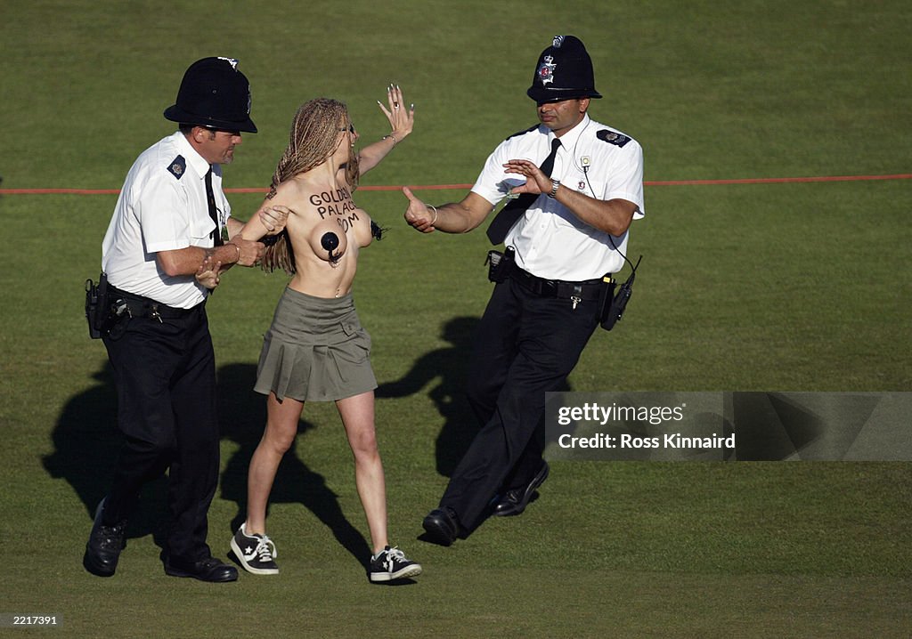 Police remove a streaker from the 18th green 