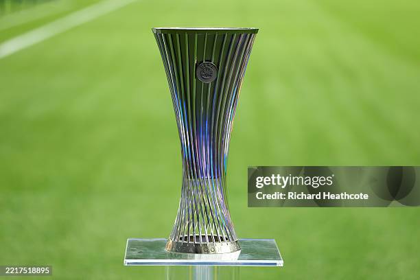 The UEFA Conference League trophy is displayed on a plinth beside the pitch ahead of the UEFA Conference League Final 2025 between Real Betis...