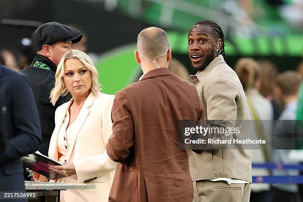 Sports presenter Emma Dodds looks on as Pundit Michail Antonio speaks to Joe Cole on a pitch side TV set ahead of the UEFA Conference League Final...