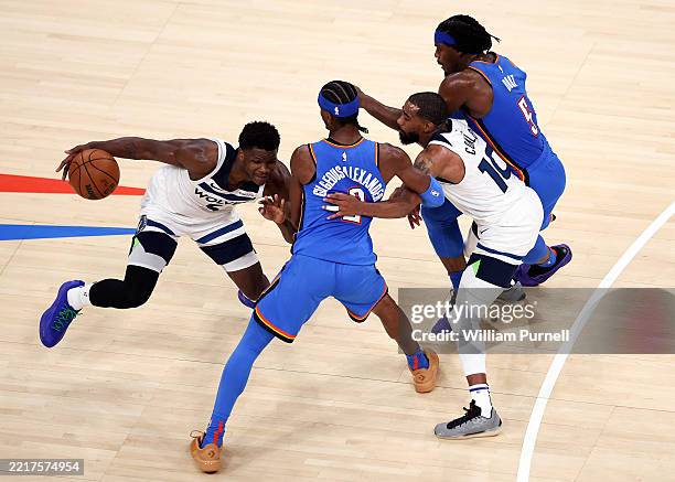 Anthony Edwards of the Minnesota Timberwolves dribbles the ball against Shai Gilgeous-Alexander of the Oklahoma City Thunder during the third quarter...