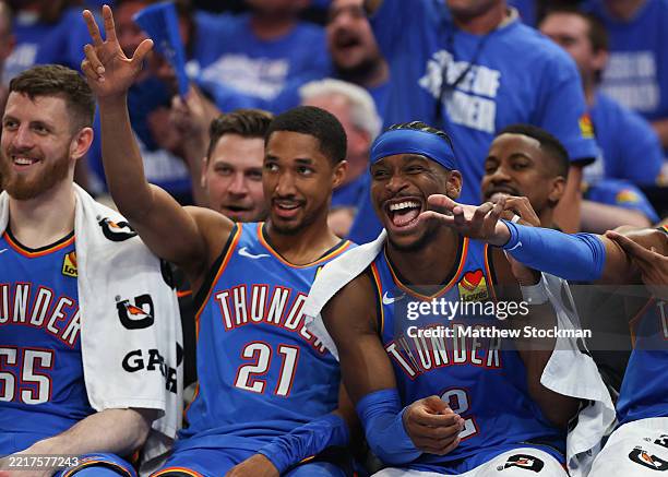 Aaron Wiggins and Shai Gilgeous-Alexander of the Oklahoma City Thunder react on the bench against the Minnesota Timberwolves during the fourth...